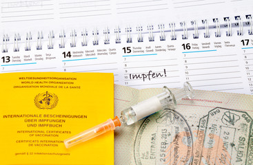 Syringe with vaccine, on vaccination certificate