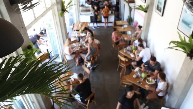Blurred background of people in the cafe in loft style. Top view. Morning relaxed concept.