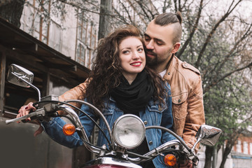 Fototapeta na wymiar young man and his girlfriend riding a motorcycle.