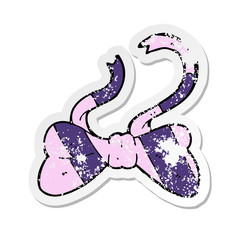 retro distressed sticker of a cartoon bow tie