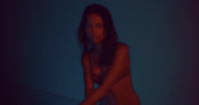 Sensual beautiful woman wearing red lace lingerie in her luxurious apartment at night - video in slow motion