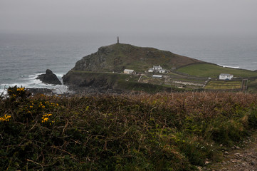 Rainy view of Cape Cornwall's lighthouse on the cliffs in West Cornwall, England, UK
