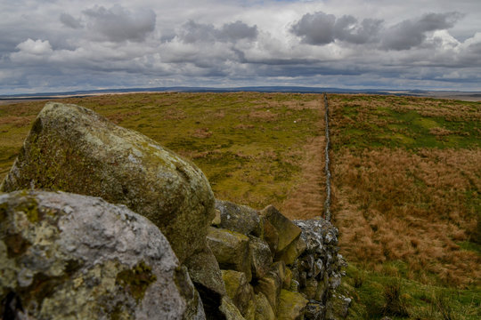 View over ancient Hadrian's wall on cloudy day in England, UK