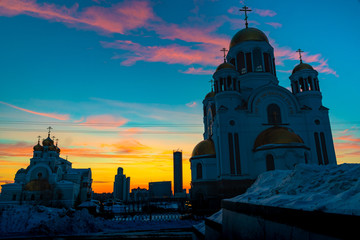 Wide angle view of soviet monument and church in Yekaterinburg at sunset