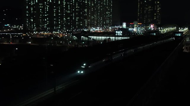 KTX train passing through the station, night scenery