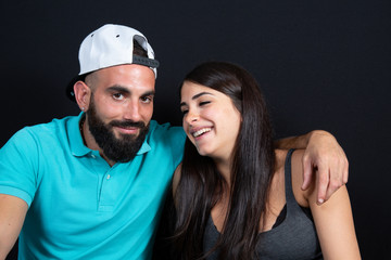 Happy couple having fun Young man with cap and laughing girlfriend