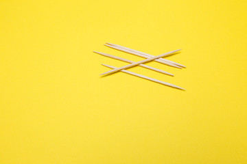 Toothpicks on a yellow isolated background