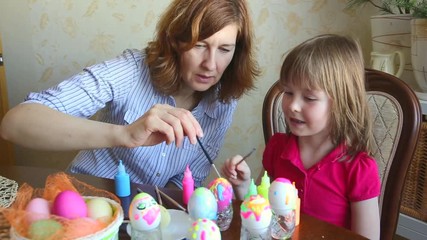 Mom and daughter have fun painting eggs for Easter. We paint eggs in bright colors.
