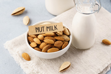 Bottle of nut milk and raw almonds. Alternative milk.