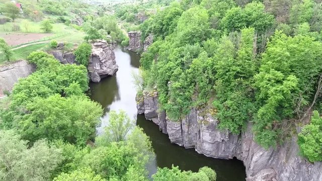 Ukrainian canyon in the village of Buki bird's-eye view. Drone removes from the height of the canyon of the Buka River, white cliffs, meadows, trees.