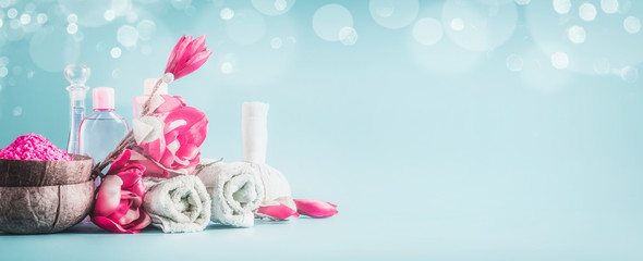 Beautiful spa setting banner or template with towels, flowers, candles and body care cosmetics at...