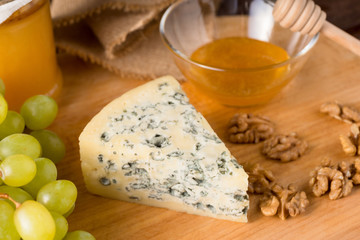 Triangle blue cheese on wooden cutting board