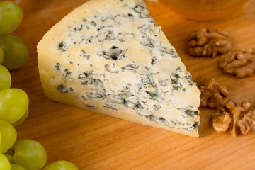 Triangle blue cheese on wooden cutting board