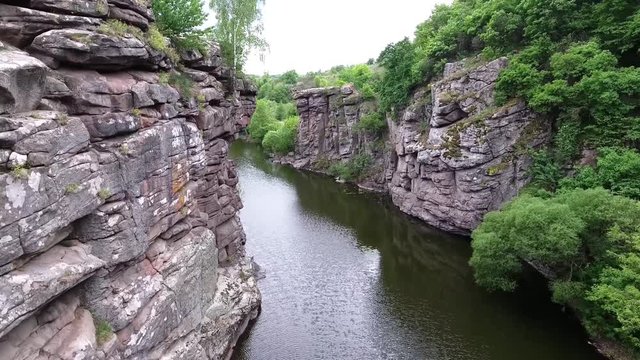 Ukrainian canyon in the village of Buki bird's-eye view. Drone removes from the height of the canyon of the Buka River, white cliffs, meadows, trees.
