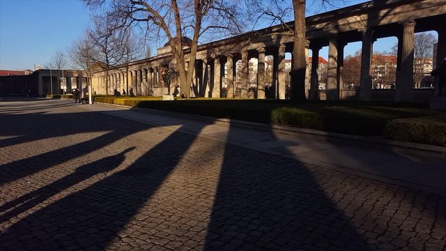 People walking on a way with pilasters in Germany. Video recorded in Germany.