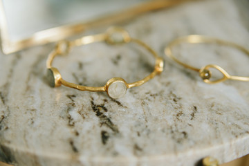 gold jewelry on marble