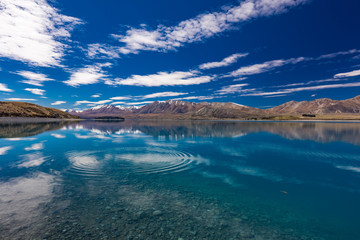 Lake Tekapo with reflection of sky and mountains, New Zealand