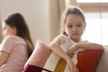 Upset kid daughter feeling sad after fight with mother