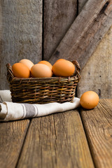 basket of eggs, old weathered wooden background