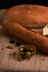 Fresh Italian baguette on wooden table with oil.Selective and soft focus