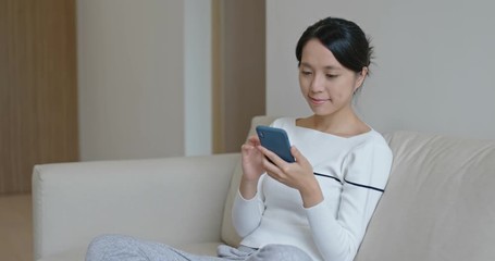 Woman use of mobile phone at home