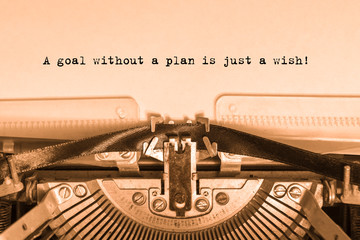 A goal without a plan is just a wish! Printed on a sheet of paper on a vintage typewriter. writer,...