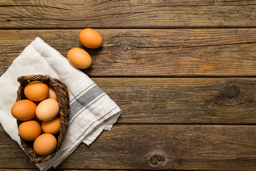 basket of eggs, old weathered wooden background