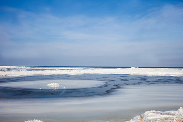 Frozen Lake. Sunny winter landscape. Extreme tourism and ice fishing