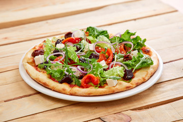 vegetarian pizza with fresh tomatoes, olives, tofu and red onion
