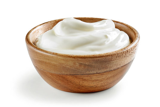 sour cream or yogurt in wooden bowl