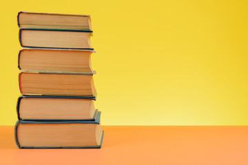 Vintage Books on Colored Paper Background.