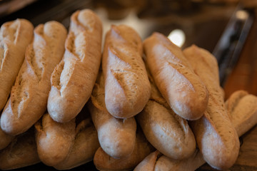 A pile of freshly baked baguette bread rolls