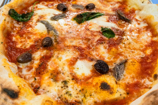 italian pizza Napoli with anchovies and olives