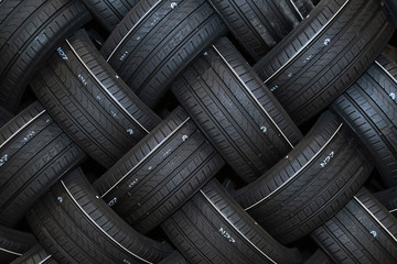 Stack of car tires with shadow deep of view. Great for backgrounds - obrazy, fototapety, plakaty