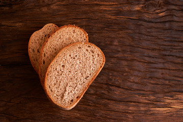 Bakery - gold rustic crusty loaves of bread and buns on black chalkboard background. Still life captured from above