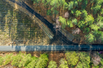 Flying above amazing multicolored forest with road, Poland
