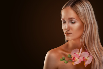 portrait of a girl. Golden shining makeup on the dark background