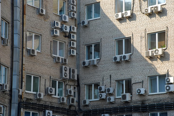 Fototapeta na wymiar aapartment building with a lot of windows and air conditioner outside