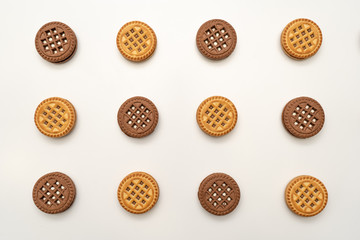 Chocolate and vanilla cookies with cream on a white background. View from above