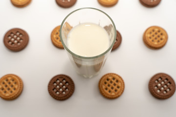 Delicious cookies and a glass of milk in the center