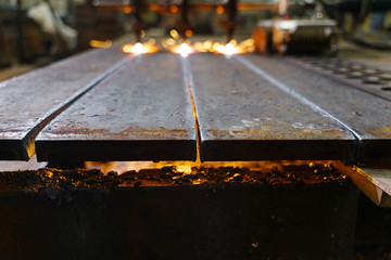 The machine cuts metal sheets with gas