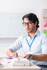 Young handsome male designer working in the office 