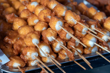 Fried balls in deep fat with sticks, Thai style food. Street fast food in Thailand, closeup