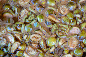 Green eggplant and green beans soup, boiled in big pot, Thai style food. Street food in local market, Thailand, closeup