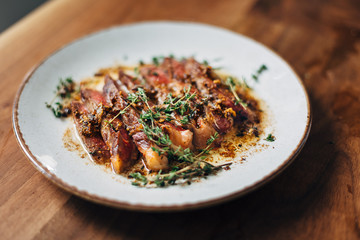 Sliced ribeye with garlic and thyme served on a plate