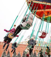 Children ride on the carousel in the park © schankz