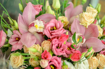 Bouquet with orchids and roses on a beautiful background