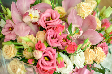 Bouquet with orchids and roses on a beautiful background