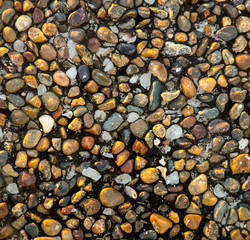 Stone pebbles on the seashore as an abstract background