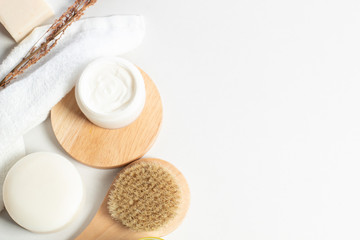 herbal with soap and bottle with facial cream with wood dish and dried flower in top view